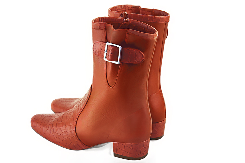 Terracotta orange women's ankle boots with buckles on the sides. Round toe. Low block heels. Rear view - Florence KOOIJMAN